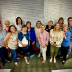 A posed group photo of women in attendance at the meeting.